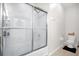 Bathroom with a glass shower enclosure, white toilet, and neutral tile at 2810 San Jacinto Cir # 2810, Sanford, FL 32771