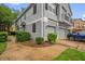 Charming townhome exterior with an attached garage, lush landscaping, and a sidewalk at 2810 San Jacinto Cir # 2810, Sanford, FL 32771