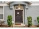 Inviting front door with a welcoming wreath, flanked by green bushes, and the house number displayed at 2810 San Jacinto Cir # 2810, Sanford, FL 32771