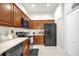 Functional kitchen with black appliances, ample cabinet space, and easy-to-clean tile flooring at 2810 San Jacinto Cir # 2810, Sanford, FL 32771