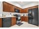 Well-lit kitchen featuring wooden cabinets, black appliances, and light countertops at 2810 San Jacinto Cir # 2810, Sanford, FL 32771