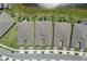 An aerial view of townhomes with well-maintained landscaping and a tranquil pond in the back at 2960 Cherry Blossom Loop, St Cloud, FL 34771