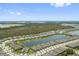 Panoramic aerial view of a vibrant community with lush greenery, scenic ponds, and modern homes at 2960 Cherry Blossom Loop, St Cloud, FL 34771