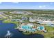 An expansive aerial view of the clubhouse, pool, tennis courts, and the surrounding neighborhood at 2960 Cherry Blossom Loop, St Cloud, FL 34771