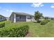 Landscaped backyard featuring manicured lawn and lush bushes with view of the pond at 2960 Cherry Blossom Loop, St Cloud, FL 34771
