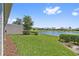 Well-maintained backyard with lush green grass and picturesque pond views at 2960 Cherry Blossom Loop, St Cloud, FL 34771