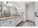 Elegant bathroom featuring double sinks, granite countertops, and a walk-in shower with glass doors at 2960 Cherry Blossom Loop, St Cloud, FL 34771