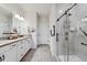 Modern bathroom with double vanity, granite countertops, and a sleek glass-enclosed walk-in shower at 2960 Cherry Blossom Loop, St Cloud, FL 34771