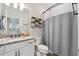 Cozy bathroom with granite countertop vanity, neutral color scheme, and shower with curtain rod at 2960 Cherry Blossom Loop, St Cloud, FL 34771