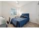 Comfortable bedroom with wood-look floors, lots of light from the large window, and ceiling fan at 2960 Cherry Blossom Loop, St Cloud, FL 34771