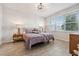 Cozy bedroom featuring twin beds, a large window, and wood-look tile flooring at 2960 Cherry Blossom Loop, St Cloud, FL 34771