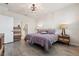 Comfortable bedroom with stylish furnishings, showcasing wood-look tile flooring and ample natural light at 2960 Cherry Blossom Loop, St Cloud, FL 34771