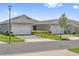 Home exterior view featuring two-car garage, manicured lawn, and appealing neighborhood landscape at 2960 Cherry Blossom Loop, St Cloud, FL 34771