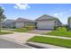 Exterior showcasing the home's garages, tidy front lawns, and the appealing neighborhood at 2960 Cherry Blossom Loop, St Cloud, FL 34771