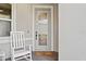 Inviting front entrance with a rocking chair, decorative welcome mat, and a glass paneled door at 2960 Cherry Blossom Loop, St Cloud, FL 34771