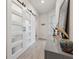 Bright hallway features stylish sliding barn doors, light wood-look flooring, and modern decor at 2960 Cherry Blossom Loop, St Cloud, FL 34771