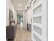 Bright hallway featuring wood floors, a decorative table, and a sliding glass door at 2960 Cherry Blossom Loop, St Cloud, FL 34771