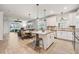 Open-concept kitchen featuring a granite island, stylish pendants, and an adjacent living space at 2960 Cherry Blossom Loop, St Cloud, FL 34771