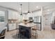 Bright kitchen featuring a large island with seating, stainless steel appliances, and white cabinetry at 2960 Cherry Blossom Loop, St Cloud, FL 34771
