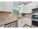 Well-lit kitchen with granite countertops, stainless steel appliances, and plenty of storage space at 2960 Cherry Blossom Loop, St Cloud, FL 34771