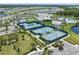 A view of the community tennis courts near the lake and clubhouse at 2960 Cherry Blossom Loop, St Cloud, FL 34771