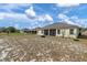 Exterior shot of home showcasing the screened patio and large backyard at 322 Huron Dr, Kissimmee, FL 34759