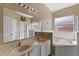 Bathroom featuring double sinks, a bathtub, and a separate shower area at 322 Huron Dr, Kissimmee, FL 34759