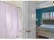 Bathroom with a pink shower curtain and a glimpse of a bedroom at 322 Huron Dr, Kissimmee, FL 34759