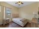 Cozy bedroom with wood floors, window, and ceiling fan at 322 Huron Dr, Kissimmee, FL 34759