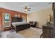 Spacious bedroom with a large bed, wood floors, and natural light at 322 Huron Dr, Kissimmee, FL 34759