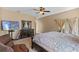 Bedroom with neutral tones, featuring a TV and dresser, with plenty of natural light at 322 Huron Dr, Kissimmee, FL 34759