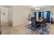 An elegant dining room with blue curtains, tiled floors and seating for eight at 322 Huron Dr, Kissimmee, FL 34759