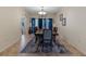 A traditionally-styled dining room with decorative blue curtains, area rug and chandelier at 322 Huron Dr, Kissimmee, FL 34759