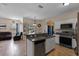 Open kitchen with stainless steel appliances leads to living area with lots of natural light at 322 Huron Dr, Kissimmee, FL 34759