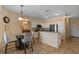 Bright eat-in kitchen with white cabinets and stainless steel appliances overlooks the dining area at 322 Huron Dr, Kissimmee, FL 34759
