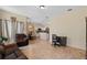 Open-concept living room with office space, tiled floors and comfortable furniture at 322 Huron Dr, Kissimmee, FL 34759