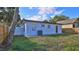 View of the backyard with wooden fence and exterior of the home, providing privacy and charm at 326 Hobart Ave, Daytona Beach, FL 32114