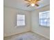 Bright bedroom features tile floors, neutral walls, a ceiling fan, and natural light from two windows at 326 Hobart Ave, Daytona Beach, FL 32114