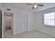 Bedroom with a ceiling fan, window, and closet, leading to an en-suite bathroom at 326 Hobart Ave, Daytona Beach, FL 32114