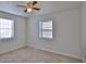 Bright bedroom featuring two windows, tile floors, and a ceiling fan for added comfort at 326 Hobart Ave, Daytona Beach, FL 32114