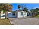 Charming home showcasing a brick driveway, lush greenery, and a well-maintained exterior at 326 Hobart Ave, Daytona Beach, FL 32114