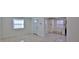 Spacious interior with natural light, showcasing tile flooring, a kitchen, and access to other rooms at 326 Hobart Ave, Daytona Beach, FL 32114
