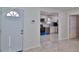 Open-concept interior featuring a modern kitchen and bright living space with shiny tile flooring at 326 Hobart Ave, Daytona Beach, FL 32114