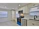 Bright kitchen with stainless steel appliances, white cabinets, and a view from the window at 326 Hobart Ave, Daytona Beach, FL 32114