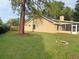 View of house from backyard showing mature landscaping and screened-in patio at 345 Feather Pl, Longwood, FL 32779