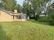 Backyard view features mature landscaping and screened in patio off of the house at 345 Feather Pl, Longwood, FL 32779