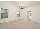 Neutral bedroom with carpet, chandelier and large window views at 345 Feather Pl, Longwood, FL 32779