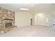 Bright living room featuring a vaulted ceiling, skylight, and a stone fireplace at 345 Feather Pl, Longwood, FL 32779