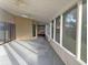 Spacious screened-in patio with ceiling fans, natural light, and neutral paint at 345 Feather Pl, Longwood, FL 32779