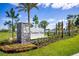 Charming Thompson Village community sign featuring stone pillar, colorful flower bed and well-manicured lawn at 350 Thompson Village Ave, Apopka, FL 32703